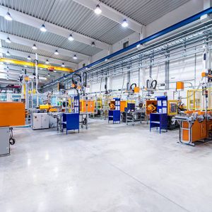 Horizontal image of huge new modern factory with robots and machines producing industrial plastic pieces and equipment. Wide angle view of futuristic machines standing on flooring and having the monopole of all work, taking the place of human work. There is not necessary use human hand. Wide angle, view, no people, space for copy.